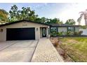Well-maintained single-story home with an attached garage and manicured landscaping at 3143 Phoenix Ave, Oldsmar, FL 34677
