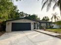 Charming single-story home featuring an attached garage and a paved walkway at 3143 Phoenix Ave, Oldsmar, FL 34677