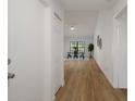 Inviting hallway with wood-look floors, leading to a dining area with natural light at 3923 Shoreside Cir, Tampa, FL 33624