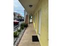 Exterior hallway view with a view of the parking lot and neighboring buildings at 4103 Gulf Blvd # 104, St Pete Beach, FL 33706