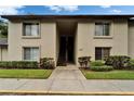 Condominium building exterior featuring a walkway and manicured landscaping at 4215 E Bay Dr # 1005D, Clearwater, FL 33764