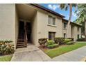 Condominium building exterior featuring a walkway and manicured landscaping at 4215 E Bay Dr # 1005D, Clearwater, FL 33764