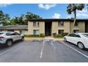 Condominium building exterior with parking lot and well-maintained landscaping at 4215 E Bay Dr # 1005D, Clearwater, FL 33764
