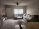 Inviting living room with a large sectional sofa, ceiling fan and natural light at 4537 Kennewick Pl # 4537, Riverview, FL 33578