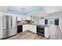Bright kitchen featuring white cabinets, stainless steel appliances, and modern backsplash at 4904 38Th S Way # 514, St Petersburg, FL 33711