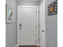 Clean and inviting entryway with a white door and neutral decor, creating a welcoming atmosphere at 5260 Coquina Key Se Dr # C, St Petersburg, FL 33705
