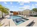 A sparkling pool with a spa and sun loungers offers a refreshing outdoor retreat at 5401 3Rd N Ave, St Petersburg, FL 33710