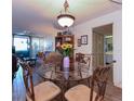 Cozy dining room featuring a glass table with seating for four and an adjacent living room area at 618 Bird Bay S Dr # 111, Venice, FL 34285
