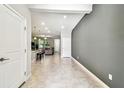 Open concept living space with tile floors and a view into the kitchen at 6745 Citrus Creek Ln, Tampa, FL 33625