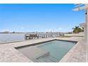 Beautiful in-ground pool on waterfront property, showcasing a tranquil outdoor living space at 7060 S Shore S Dr, South Pasadena, FL 33707