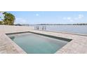Stunning in-ground pool with beautiful waterfront views for a relaxing experience at 7060 S Shore S Dr, South Pasadena, FL 33707
