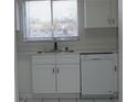 Bright kitchen showcases white cabinets and a stainless dishwasher at 7927 Kosi Palm Pl # 201, Tampa, FL 33615
