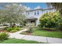 Two-story home with lush landscaping, mature trees, and a charming front yard at 795 26Th N Ave, St Petersburg, FL 33704
