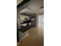 Bright kitchen featuring white cabinets, stainless steel appliances, and an eat-in bar area at 807 E Elm St, Tampa, FL 33604