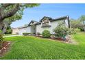 Attractive home with well-kept lawn, flower beds, and architectural accent window at 8135 Golf Club Ct, Hudson, FL 34667