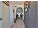 Inviting entryway with tiled flooring, arched doorway, and a glimpse into the living area at 8702 Congress St, Port Richey, FL 34668