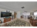 Spacious living room featuring tile floors and comfortable seating, perfect for Gathering gatherings at 8702 Congress St, Port Richey, FL 34668