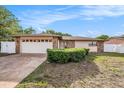 Charming single-story home boasts stone accents, a two-car garage, and a well-manicured front yard at 8744 Andros Ln, Port Richey, FL 34668