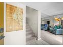 Inviting entryway with stairs and an open living space with modern decor and neutral colors at 9209 Seminole Blvd # 156, Seminole, FL 33772