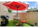 Cozy patio with an umbrella-covered table and grill, perfect for outdoor dining and entertaining at 9209 Seminole Blvd # 156, Seminole, FL 33772