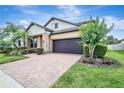 Beautiful home with lush landscaping, a brick driveway, and a well-maintained lawn at 10415 Cardera Dr, Riverview, FL 33578