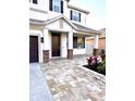 Stunning front entrance with beautiful brick columns, paver walkway and well-maintained landscaping at 1147 Halapa Way, Trinity, FL 34655