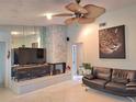 Cozy living room featuring a stone fireplace and modern furnishings at 1291 Stony Brook Ln, Dunedin, FL 34698