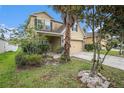 Charming two-story home featuring an attached two-car garage, complemented by lush landscaping at 13246 Kent Bradley St, Dade City, FL 33525