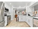 Bright, updated kitchen featuring white cabinets, stainless steel appliances, and tile flooring at 13263 86Th Ave, Seminole, FL 33776