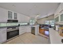 Well-equipped kitchen features stainless steel appliances and white cabinetry at 14502 Pond Cypress Way, Tampa, FL 33626