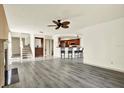 Bright living area with hardwood floors, fireplace, and kitchen breakfast bar at 14561 El Paseo Dr, Seminole, FL 33776