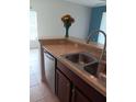 Kitchen with a stainless steel double sink and neutral countertops at 1508 Talisker Dr, Clearwater, FL 33755