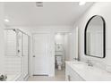 Sleek bathroom featuring tile flooring, glass-enclosed shower, toilet, vanity, and modern black mirror at 17729 Nectar Flume Dr, Land O Lakes, FL 34638