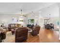 Spacious living room featuring hardwood floors, ceiling fan, and comfortable leather furniture set at 1914 Elk Spring Dr, Brandon, FL 33511