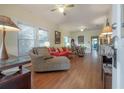 Bright living room with hardwood floors, large windows, and vintage furniture at 204 E North St, Tampa, FL 33604