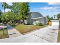 Charming home with driveway, landscaped yard, and detached garage offers curb appeal at 2078 Madrid N Ct, Clearwater, FL 33763
