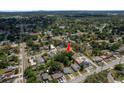 Wide aerial shot shows property's location amidst lush greenery in a tranquil neighborhood setting at 2104 E Navajo Ave, Tampa, FL 33612