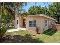 Exterior view of the home surrounded by lush landscaping, enhancing its curb appeal at 2104 E Navajo Ave, Tampa, FL 33612
