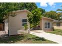 Charming single-story home with a well-maintained front yard and a cozy entryway seating area at 2104 E Navajo Ave, Tampa, FL 33612