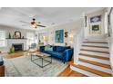 Comfortable living room features a fireplace, hardwood floors, and staircase, creating a warm and inviting atmosphere at 221 13Th Ne Ave, St Petersburg, FL 33701