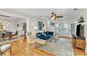 Spacious living room with hardwood floors and ample natural light, seamlessly flowing into the dining area and kitchen at 221 13Th Ne Ave, St Petersburg, FL 33701