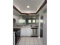 Functional kitchen with stainless steel appliances, recessed lights, and easy access to adjacent room at 2753 Countryside Blvd # 107, Clearwater, FL 33761