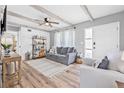 Inviting living room featuring wood beam ceilings, wood floors, and stylish furnishings at 2858 State Road 590, Clearwater, FL 33759