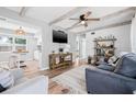 Inviting living room featuring wood beam ceilings, wood floors, and stylish furnishings at 2858 State Road 590, Clearwater, FL 33759