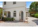 Inviting entryway with stone path, garden, and arched doorway leading to the home at 2936 W Knights Ave # A, Tampa, FL 33611