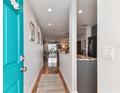 Bright hallway leading to living spaces with hardwood floors, and neutral decor at 2960 59Th S St # 614, Gulfport, FL 33707