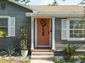 Close-up of the entry with coral-colored front door and decorative wreath at 3305 10Th N Ave, St Petersburg, FL 33713