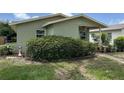 Modest single-story home featuring lush front yard landscaping at 3827 15Th N Ave, St Petersburg, FL 33713