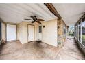 Enclosed patio featuring a ceiling fan, stone accents, and multiple entry doors at 4312 Las Vegas Dr, New Port Richey, FL 34653