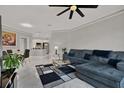 Living room featuring a gray sectional sofa, tile flooring, contemporary decor, and open to the dining and kitchen at 4333 Bayside Village Dr # 110, Tampa, FL 33615
